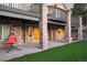 Covered patio with stone pillars, concrete floor, and an orange swing chair in the backyard at 6047 Vacquero Cir, Castle Pines, CO 80108