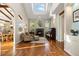 Sitting room featuring hardwood floors, fireplace, and large windows at 6047 Vacquero Cir, Castle Pines, CO 80108