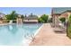 An outdoor swimming pool is surrounded by lounge chairs and bordered by a fenced pool area at 6047 Vacquero Cir, Castle Pines, CO 80108