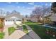 Expansive backyard featuring a detached garage, patio area, and mature trees at 1958 S Pearl St, Denver, CO 80210