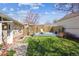 Private backyard featuring a wooden fence, small elevated deck, and lush lawn at 1958 S Pearl St, Denver, CO 80210
