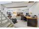 Finished basement with stairs, wood desk, computer, and exercise equipment at 1958 S Pearl St, Denver, CO 80210