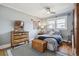 Cozy bedroom featuring wood floors, a ceiling fan, and a patterned blue and white comforter at 1958 S Pearl St, Denver, CO 80210