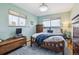 Bright bedroom featuring wood floors, light-blue walls, and warm natural light at 1958 S Pearl St, Denver, CO 80210