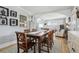 Open concept dining room leading to living room with hardwood floors and neutral wall color at 1958 S Pearl St, Denver, CO 80210