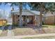 Quaint brick bungalow with a cozy front porch, mature trees, and charming curb appeal at 1958 S Pearl St, Denver, CO 80210