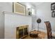 Close up of a fireplace featuring a basket of wood and wall decor at 1958 S Pearl St, Denver, CO 80210