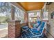 Relax on the covered front porch with comfortable seating and classic brick accents at 1958 S Pearl St, Denver, CO 80210