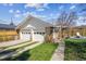 Detached two-car garage with ample driveway space and well-kept landscaping at 1958 S Pearl St, Denver, CO 80210