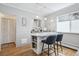 Kitchen island featuring bar seating, marble countertop, and shelving for storage at 1958 S Pearl St, Denver, CO 80210