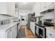 Charming kitchen featuring white cabinets, updated appliances, and stone countertops at 1958 S Pearl St, Denver, CO 80210