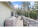 Wide wooden deck overlooks a forest setting and snow-covered ground at 8340 London Ln, Conifer, CO 80433