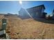 Home exterior with a large, unfinished backyard and a blue sky at 490 Grey Rock St, Brighton, CO 80601