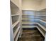 A walk-in pantry with multiple shelves provides ample storage space for all your kitchen needs at 490 Grey Rock St, Brighton, CO 80601