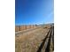 Community walking path with wooden fence, adding privacy and charm to the neighborhood landscape at 490 Grey Rock St, Brighton, CO 80601