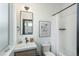 Bathroom with a modern vanity and a shower-tub combo with white tile at 1260 Newton St # 1, Denver, CO 80204