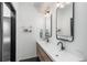 Modern bathroom featuring a double vanity with sleek fixtures and contemporary design elements at 1260 Newton St # 1, Denver, CO 80204