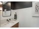 Stylish powder room with a modern vanity and striking black-and-white color scheme at 1260 Newton St # 1, Denver, CO 80204