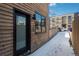 Exterior side view of modern home, with a fenced walkway and stylish architectural details at 1260 Newton St # 1, Denver, CO 80204