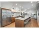 Modern kitchen with stainless steel appliances, island with seating, and sleek countertops at 1260 Newton St # 1, Denver, CO 80204