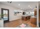 Open concept living space featuring wood flooring, a stylish kitchen island, and ample natural light at 1260 Newton St # 1, Denver, CO 80204