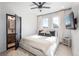 Bedroom with a ceiling fan, tv, and light-colored walls at 1260 Newton St # 1, Denver, CO 80204