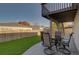 Covered patio featuring outdoor seating, perfect for entertaining guests, and a well-manicured yard with green grass at 19563 E Ithaca Pl, Aurora, CO 80013