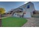 Lovely backyard showcasing a deck, patio area with a table and chairs, lush green grass, and a well-maintained exterior at 19563 E Ithaca Pl, Aurora, CO 80013