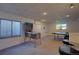 Basement area with a pinball machine, ping pong table, egress window, and bar with stools at 19563 E Ithaca Pl, Aurora, CO 80013