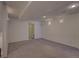 Basement room featuring neutral carpet and a view into the bathroom with a shower at 19563 E Ithaca Pl, Aurora, CO 80013