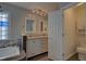 Bathroom boasting double sinks, stylish mirrors and tub at 19563 E Ithaca Pl, Aurora, CO 80013