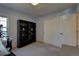 Neutral bedroom containing a black bookcase and desk with chair at 19563 E Ithaca Pl, Aurora, CO 80013