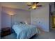 Inviting bedroom featuring a ceiling fan, a comfortable bed, and a tranquil space for relaxation at 19563 E Ithaca Pl, Aurora, CO 80013