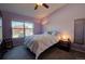 Cozy bedroom with a ceiling fan, comfortable bed, and a bright window offering scenic neighborhood views at 19563 E Ithaca Pl, Aurora, CO 80013