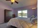 Charming bedroom with a well-lit ceiling fan, and a sun-drenched window highlighting the room's cozy appeal at 19563 E Ithaca Pl, Aurora, CO 80013