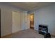 Neutral toned bedroom with closet doors and view of an open door and staircase at 19563 E Ithaca Pl, Aurora, CO 80013