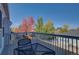 Upper deck showcasing seasonal foliage, with a table and chairs on the deck and a view of the fenced back yard at 19563 E Ithaca Pl, Aurora, CO 80013