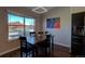 The dining room features hardwood floors, natural light and a modern light fixture at 19563 E Ithaca Pl, Aurora, CO 80013