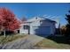 Charming single-Gathering home with a well-maintained lawn, a mature tree with vibrant fall foliage, and an attached two-car garage at 19563 E Ithaca Pl, Aurora, CO 80013