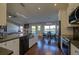 Open kitchen and dining area with stainless steel appliances and modern lighting fixtures at 19563 E Ithaca Pl, Aurora, CO 80013