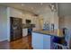 Kitchen showcasing stainless steel appliances, modern cabinets, and a kitchen island with seating at 19563 E Ithaca Pl, Aurora, CO 80013