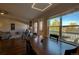 Bright living room with hardwood floors, fireplace, modern lighting and access to a balcony at 19563 E Ithaca Pl, Aurora, CO 80013