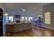 Spacious living room featuring hardwood floors, a fireplace, and access to the kitchen and dining area at 19563 E Ithaca Pl, Aurora, CO 80013