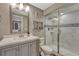 Bathroom with a sliding glass shower door and white marbled tile surround at 5819 W 82Nd Cir, Arvada, CO 80003