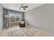 Cozy bedroom with a ceiling fan, window, and a comfortable chair next to a modern lamp at 5819 W 82Nd Cir, Arvada, CO 80003