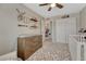 Bedroom with dresser, shelves and decor next to bi-fold doors at 5819 W 82Nd Cir, Arvada, CO 80003