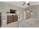 Comfortable main bedroom with neutral tones, a ceiling fan, ensuite bath, and a dresser for ample storage space at 5819 W 82Nd Cir, Arvada, CO 80003