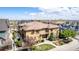 An aerial shot showcasing the tan residences, complemented by mature landscaping and a well-maintained walkway at 7777 E 23Rd Ave # 1406, Denver, CO 80238
