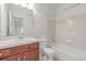 Bright bathroom featuring a vanity with white countertop, wood cabinets, and a shower-tub combination at 7777 E 23Rd Ave # 1406, Denver, CO 80238