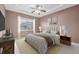 Bedroom featuring neutral walls, carpet, ceiling fan and a large window at 7777 E 23Rd Ave # 1406, Denver, CO 80238